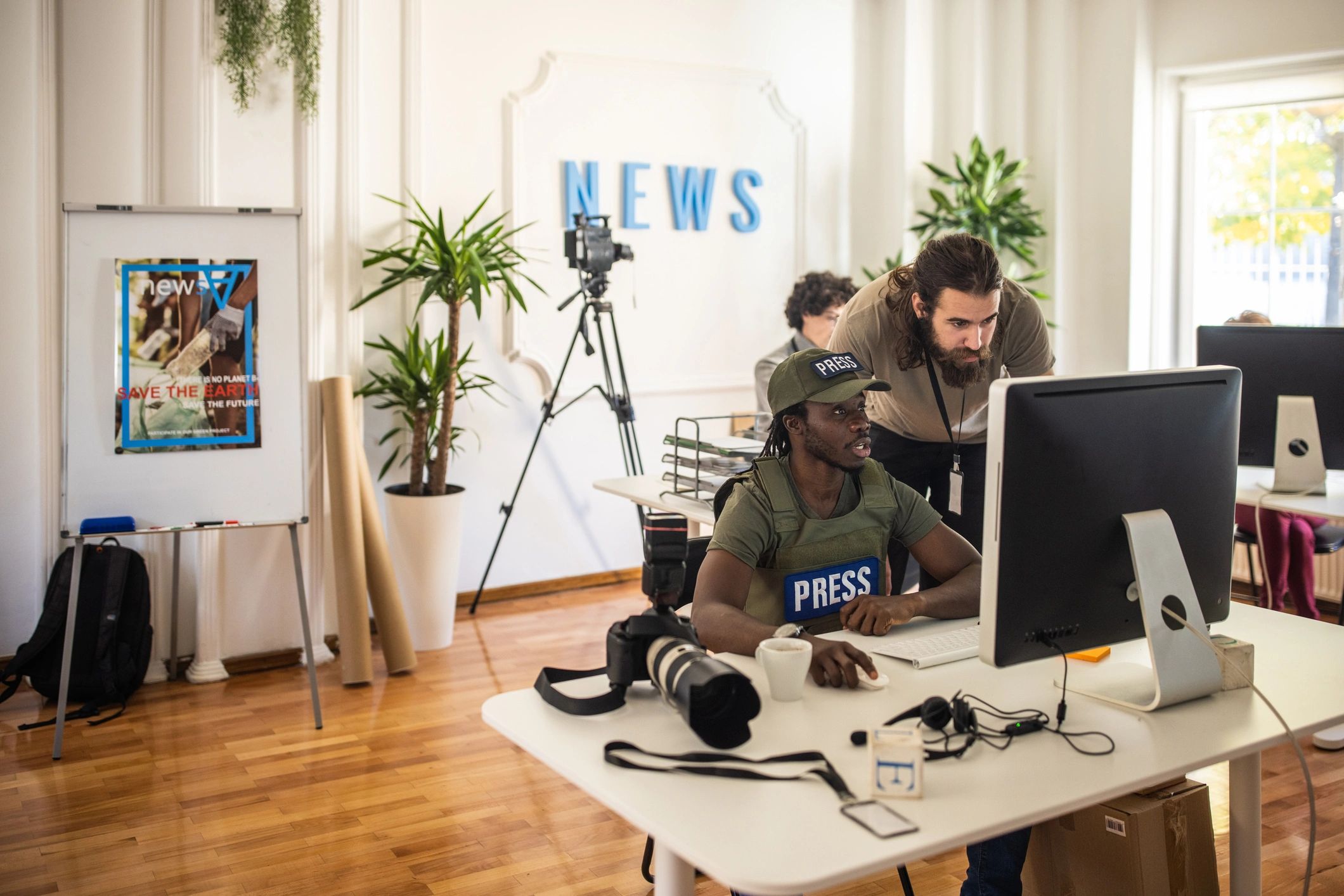Research-focused media professional in a modern editorial office