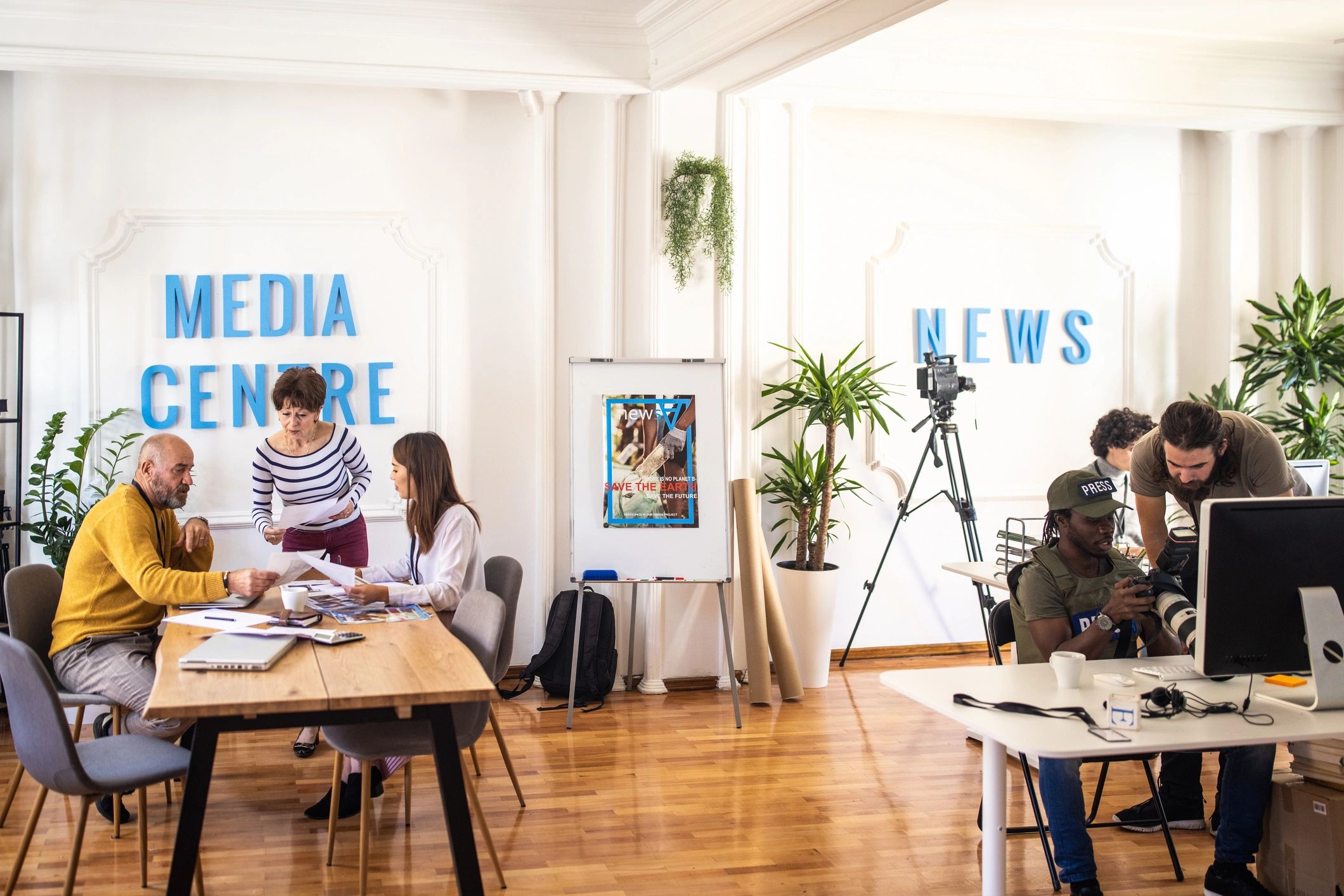Modern editorial staff working together in a collaborative media office