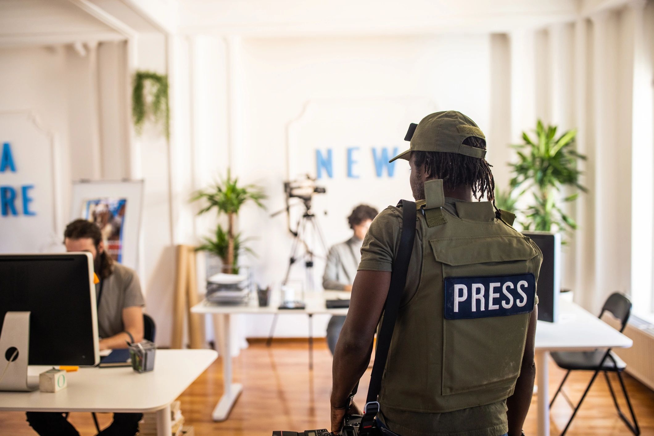 Editorial photographer arriving at a modern media office