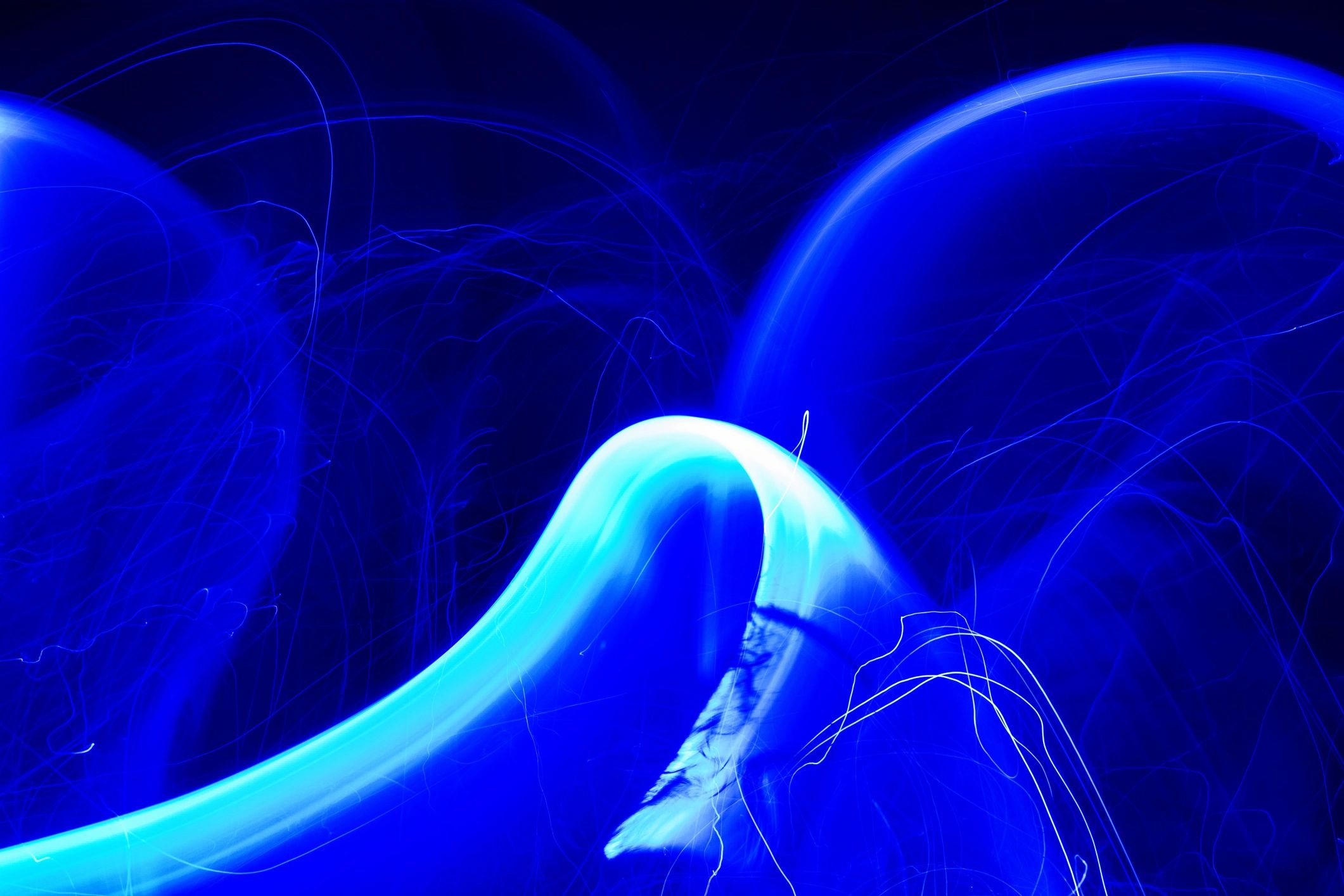 Electric blue LED wave pattern on dark background